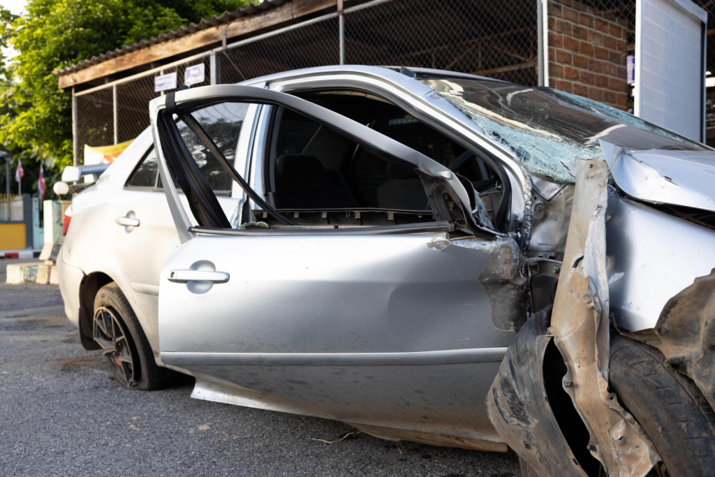 A close-up view of the condition of a silver-colored sedan destroyed in an accident